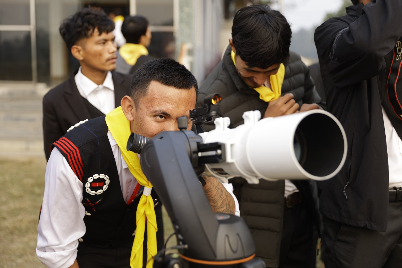 watching the sun through a telescope with a protective lens