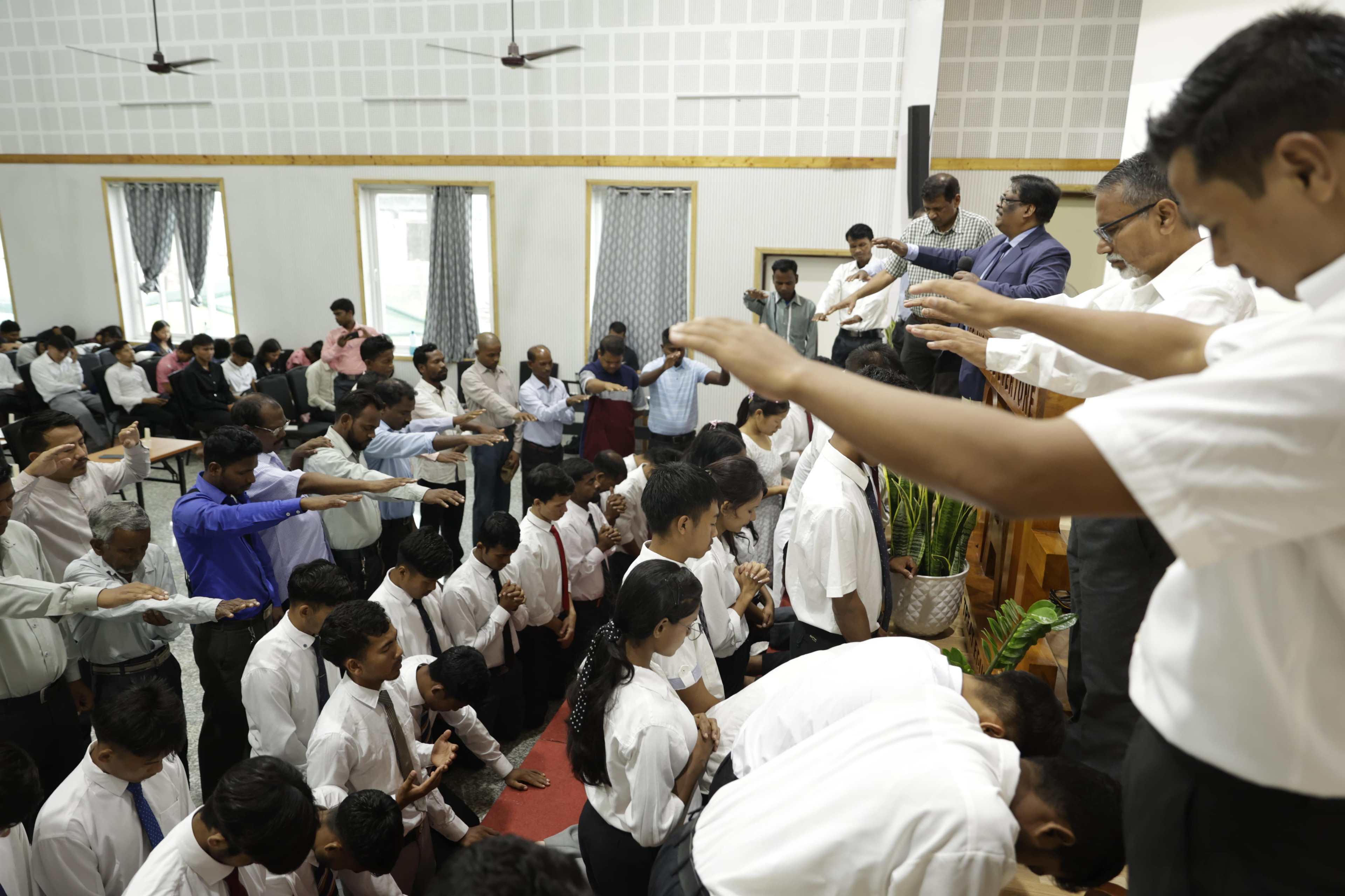 leaders praying for the students